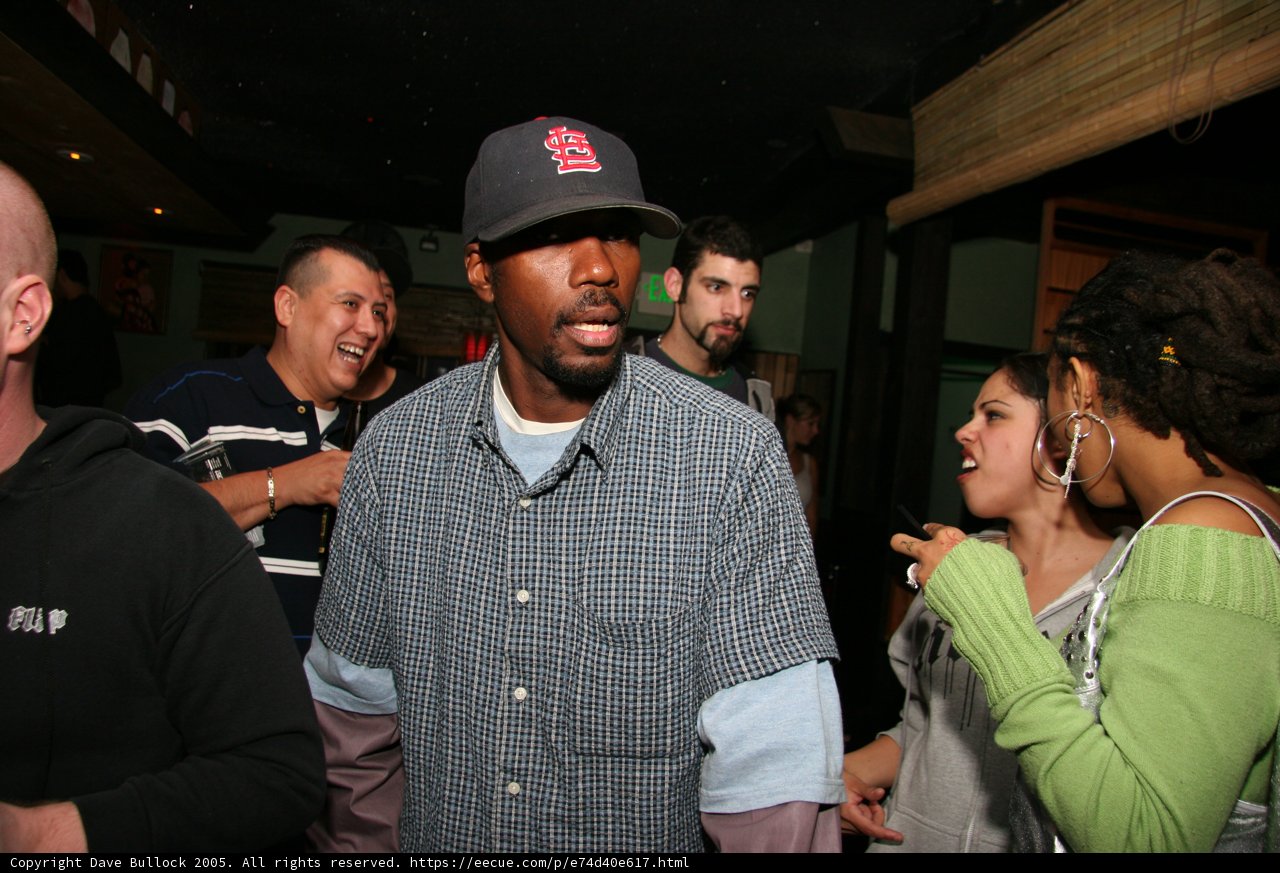 Blue Shirt, Baseball Cap, and Happy Crowd