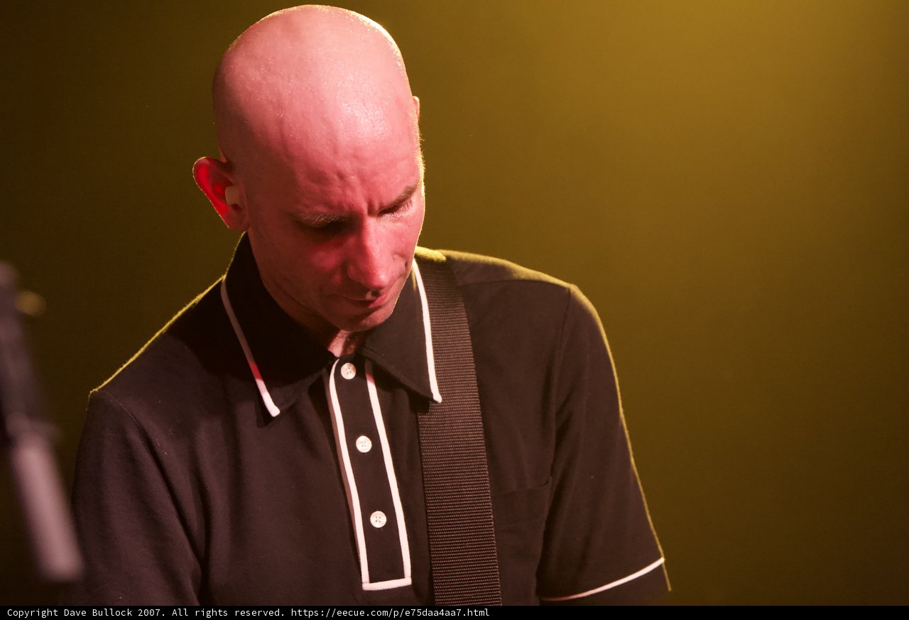 Bald Man Rocking Out on Stage