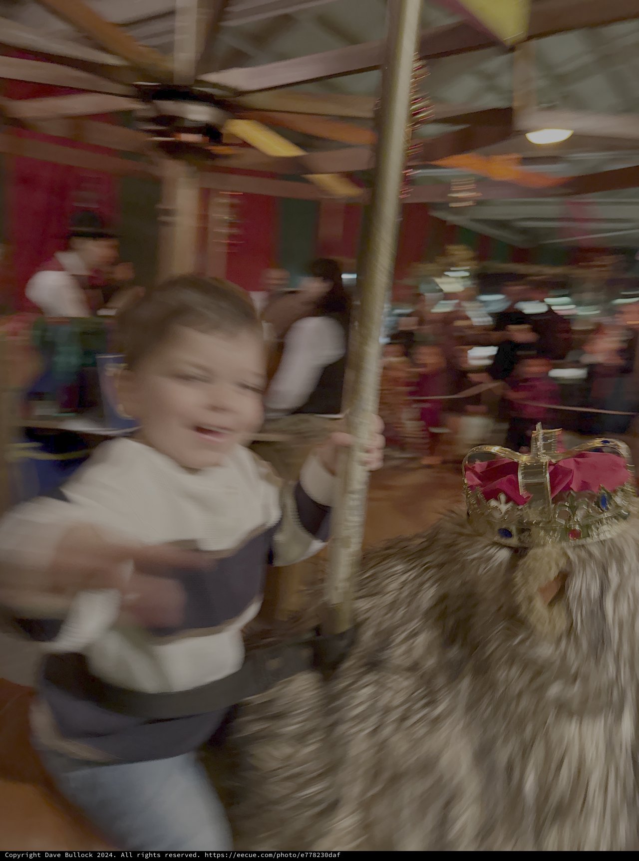 Joyful Child Riding Carousel Horse at Amusement Park
