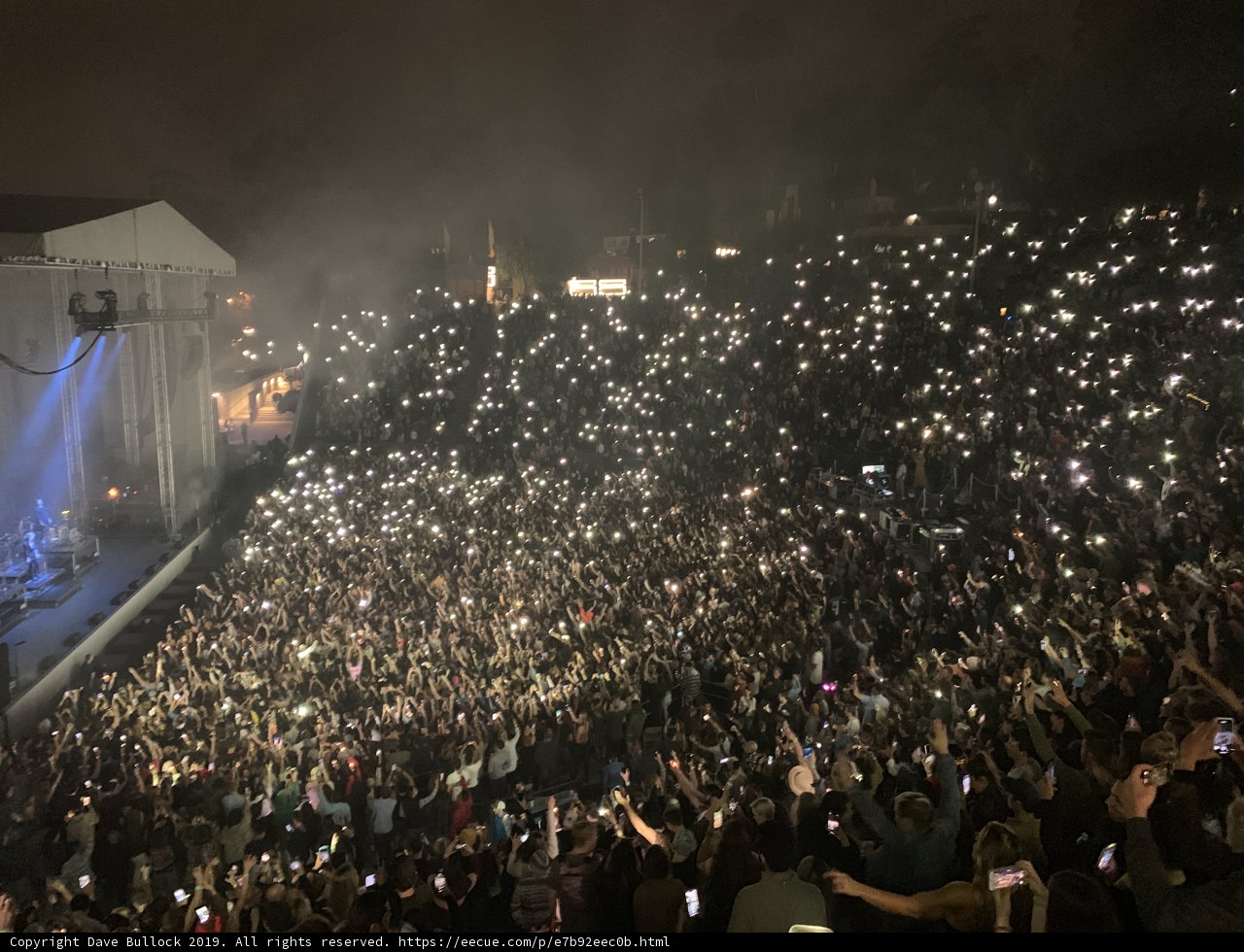 Phone-lit Crowd Rocks Out under Night Sky