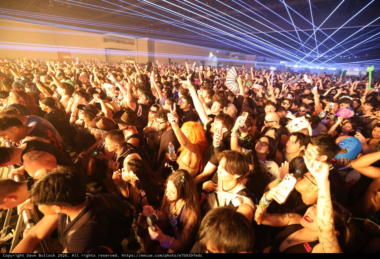 Massive Indoor Rave Crowd Under Electric Laser Light Show