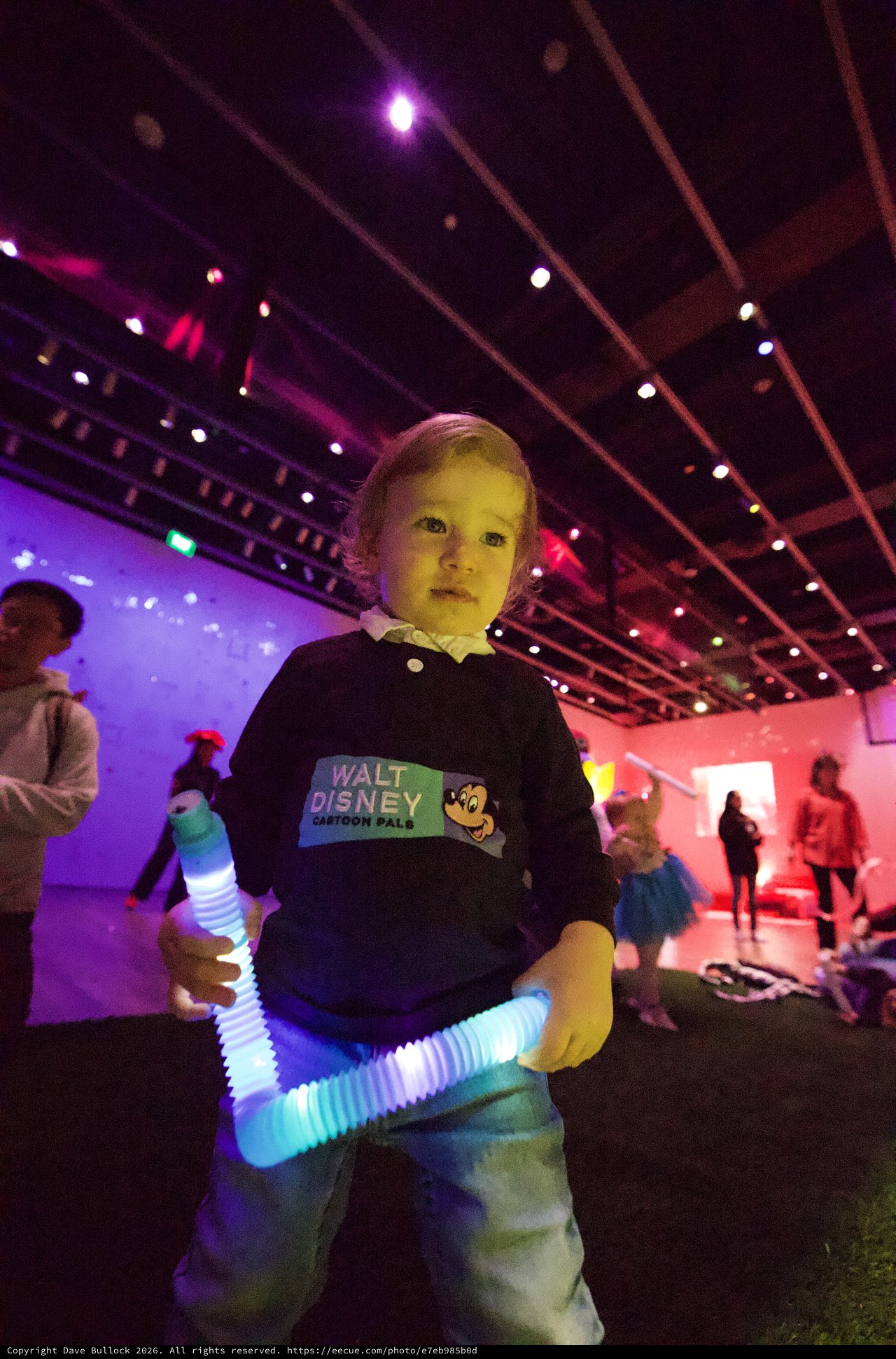 Young Child at Baby Rave with Glowing Light Toy