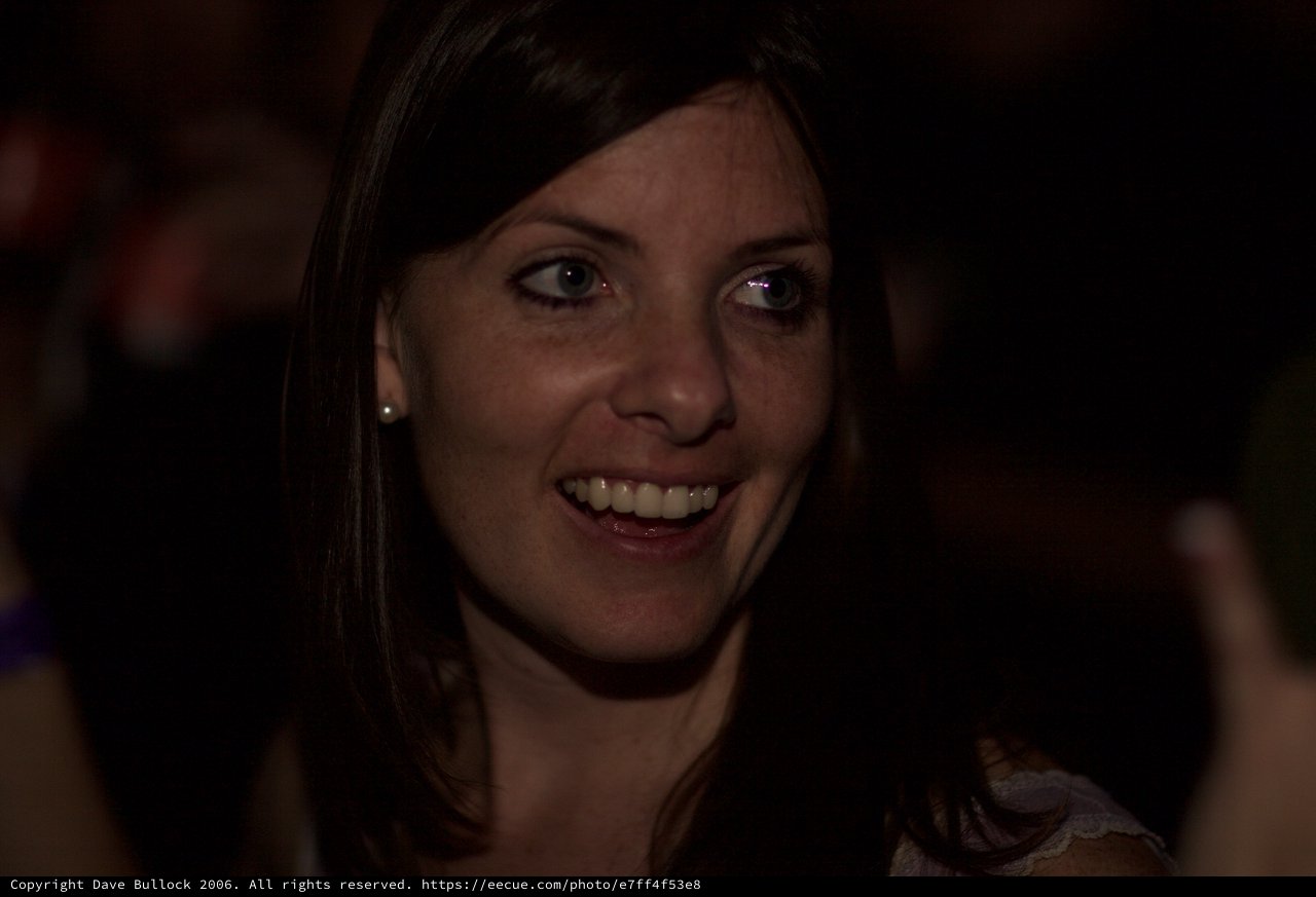 Candid Smile in the Darkness of a Dimly Lit Venue