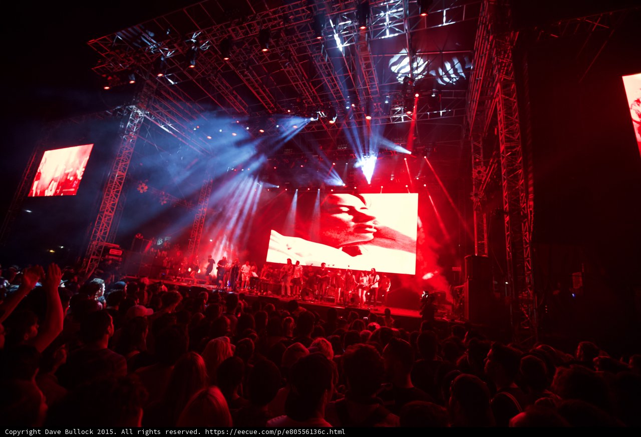Belle and Sebastian Wide Stage Video Screen Romantic Red Lighting Spotlight Hand Raised Crowd
