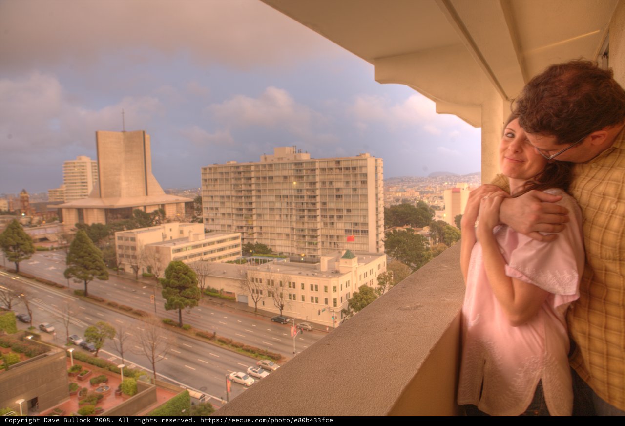 New Parents Embrace Newborn on San Francisco Balcony