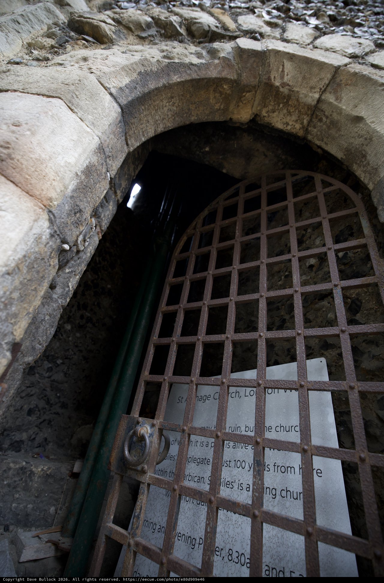 Ancient Stone Archway with Rusted Iron Gate