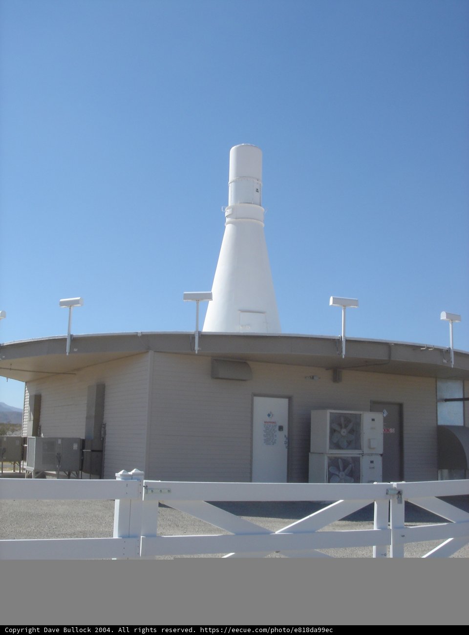 Serene White Building with a White Fence