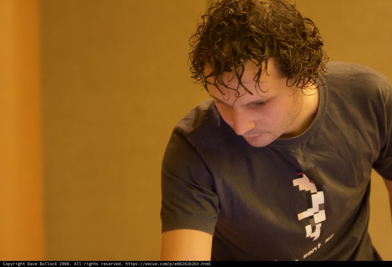 Curly-haired man sporting a T-shirt