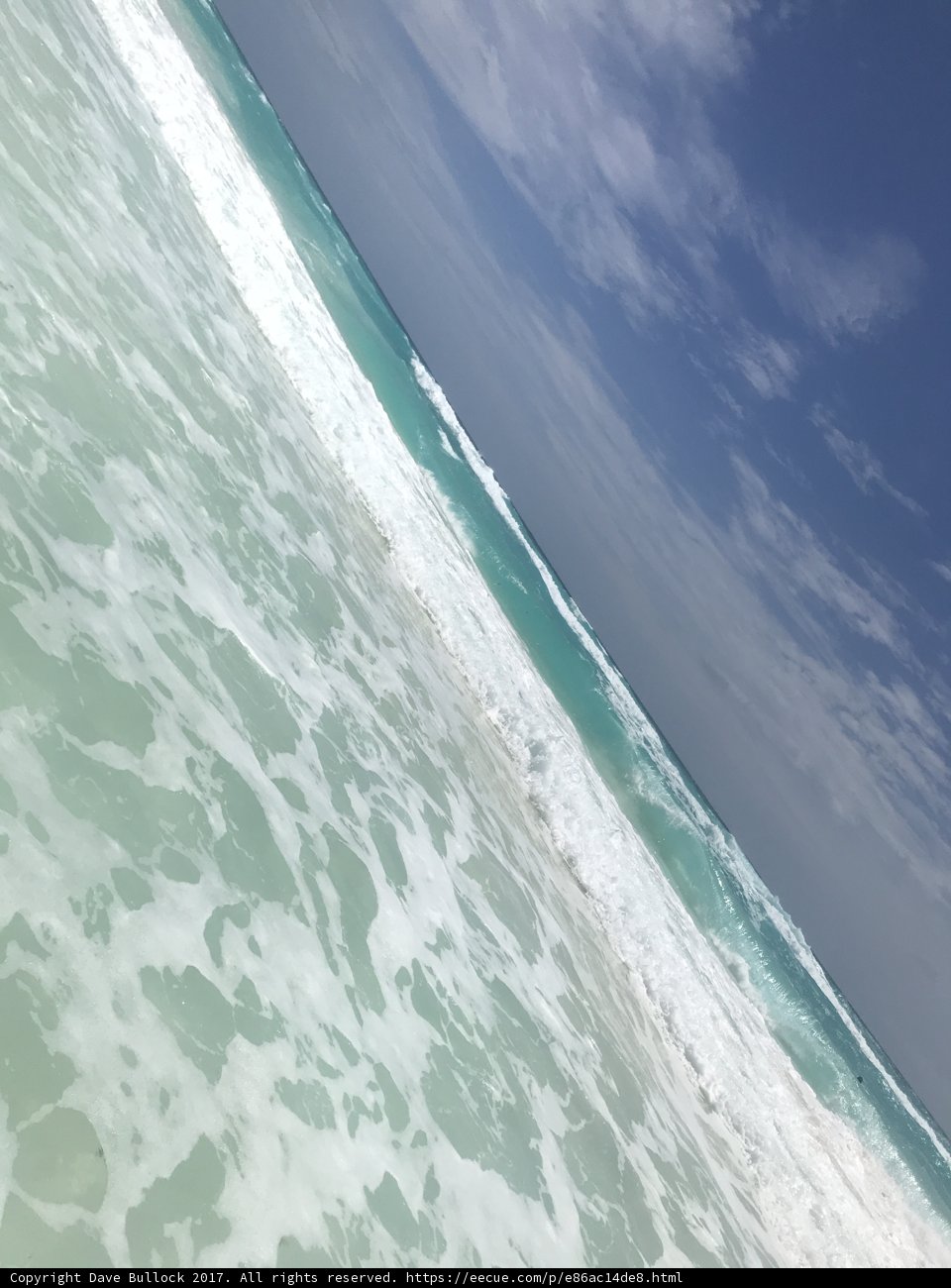 Aerial View of Turquoise Sea and Cloudy Sky