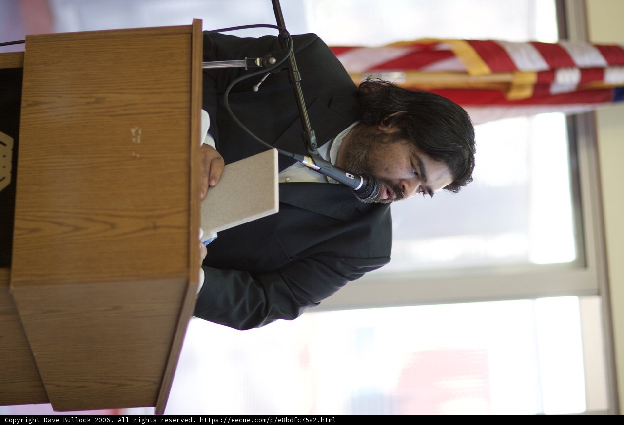 Suited-Up Speaker on Plywood Podium