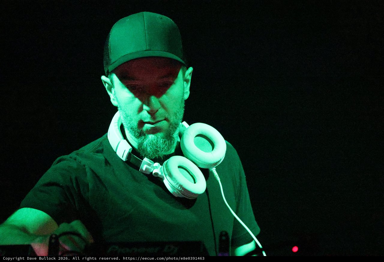 DJ Focused Under Green Stage Lights at Wobbleland