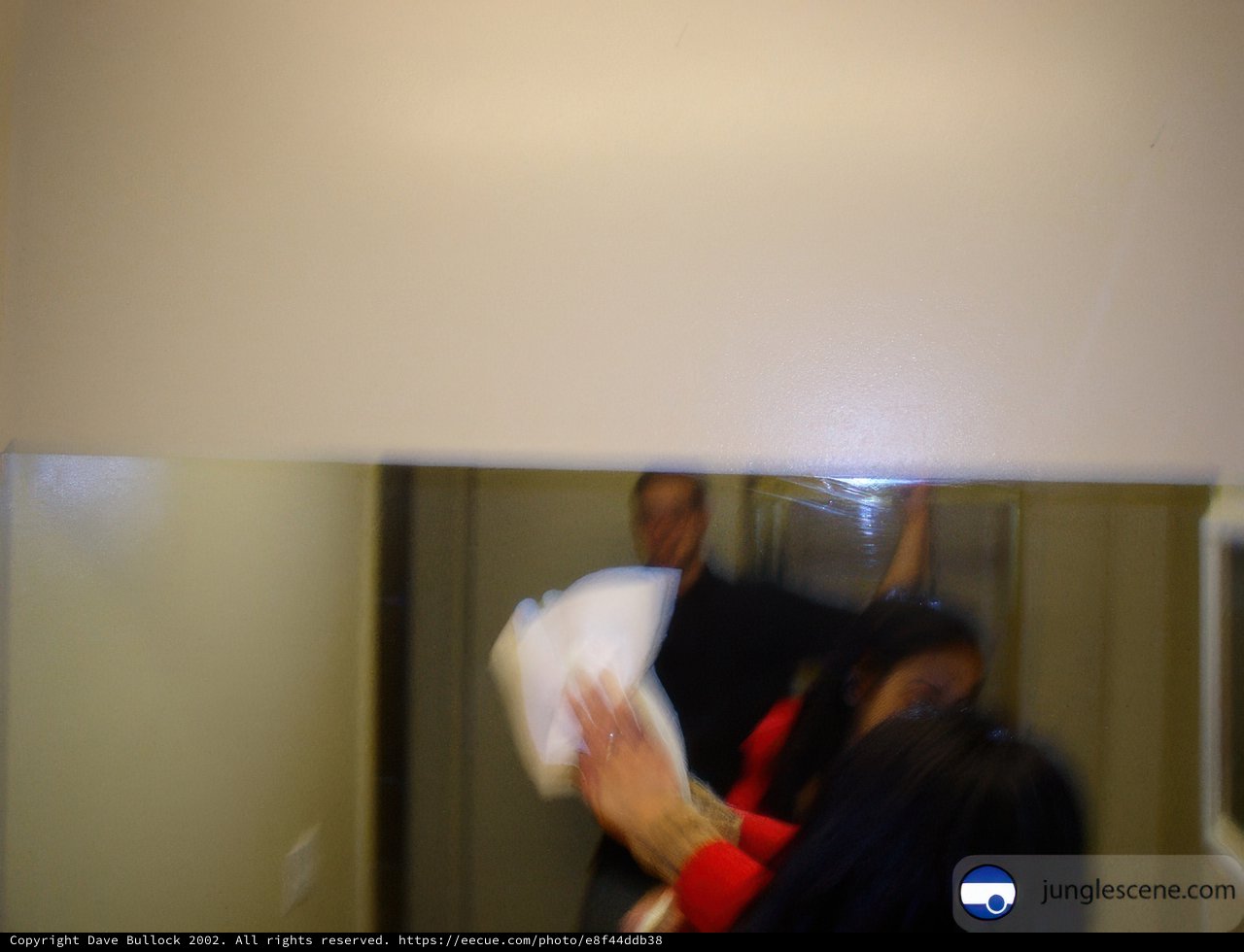 Woman holding a white cloth near the sliding door