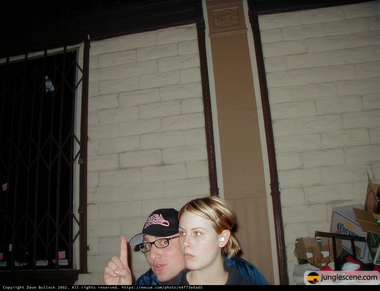 Couple Poses in Front of Brick Building