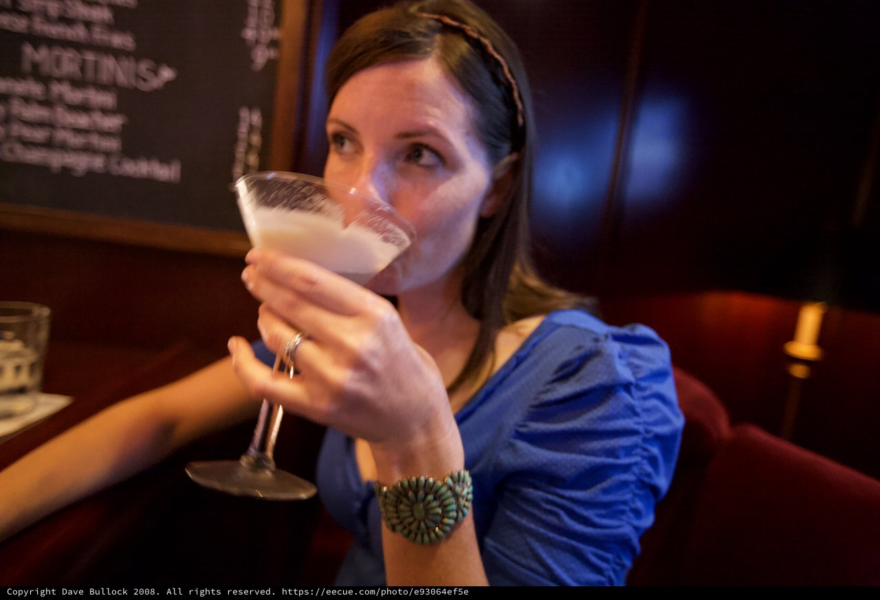 Woman Sipping Martini at Upscale Cocktail Bar