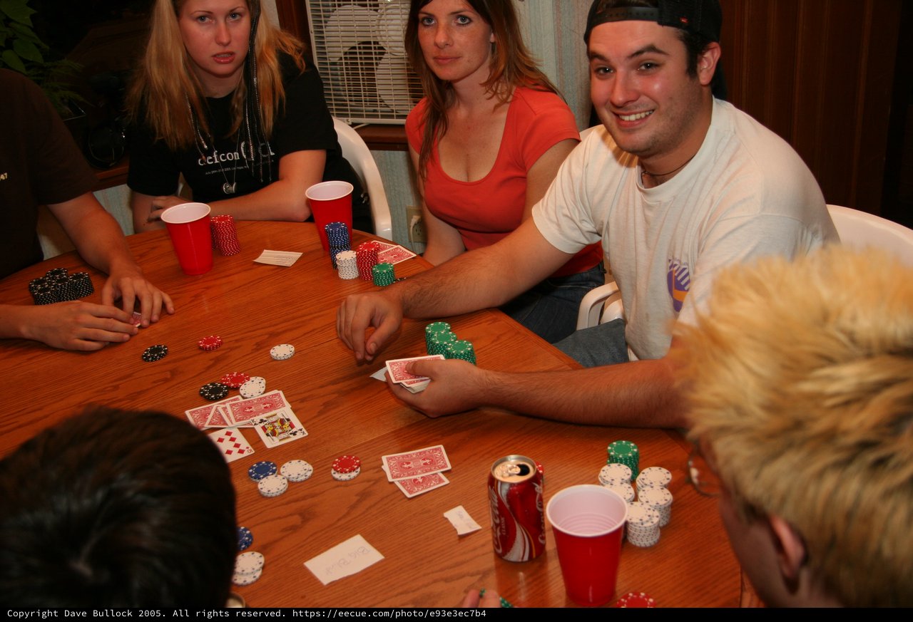 Friends Gathered Around Table for Poker Night