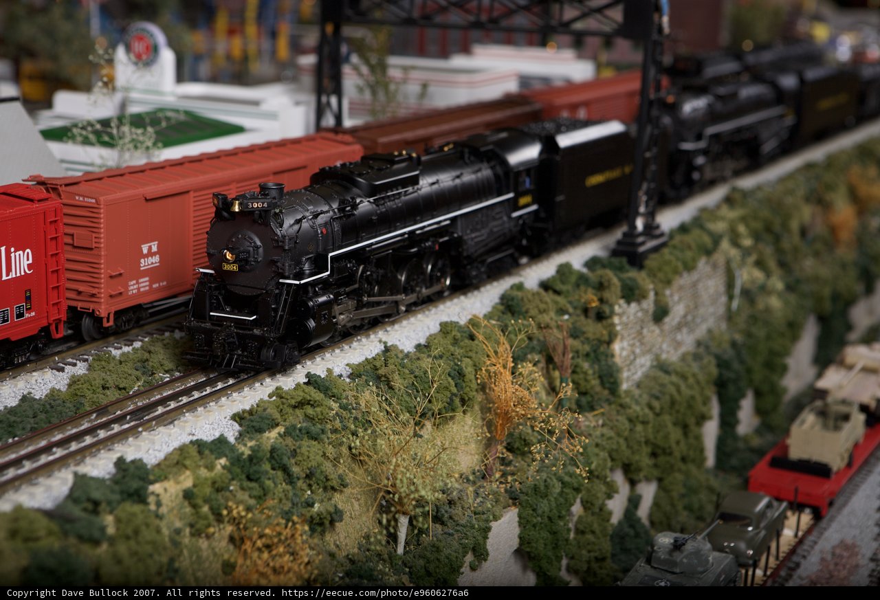 Three Toy Trains on Railway Tracks