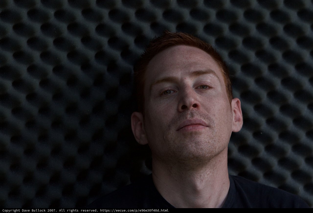 Introspective Man on a Black Wall