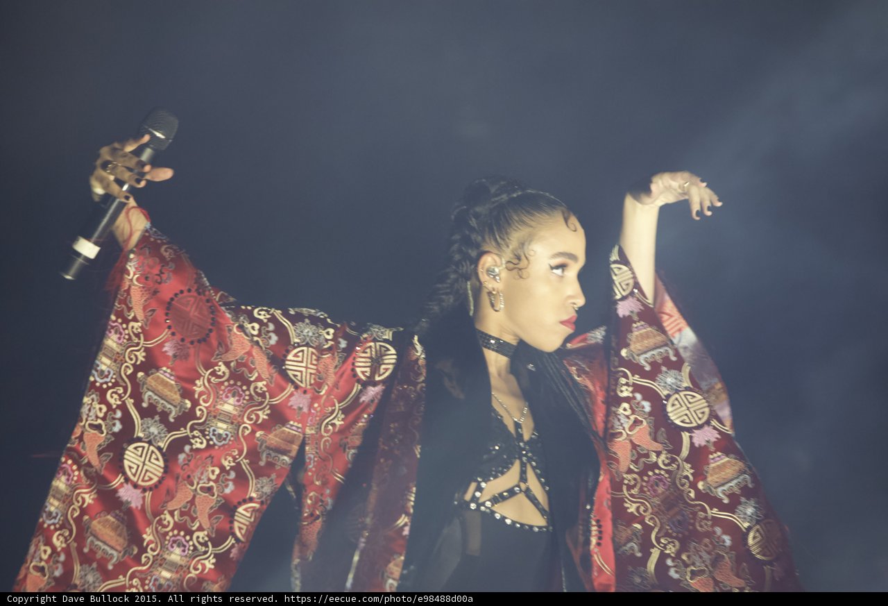 FKA twigs Profile Both Arms Extended Microphone Red Brocade Kimono Baby Hairs Black Choker Red Lipstick