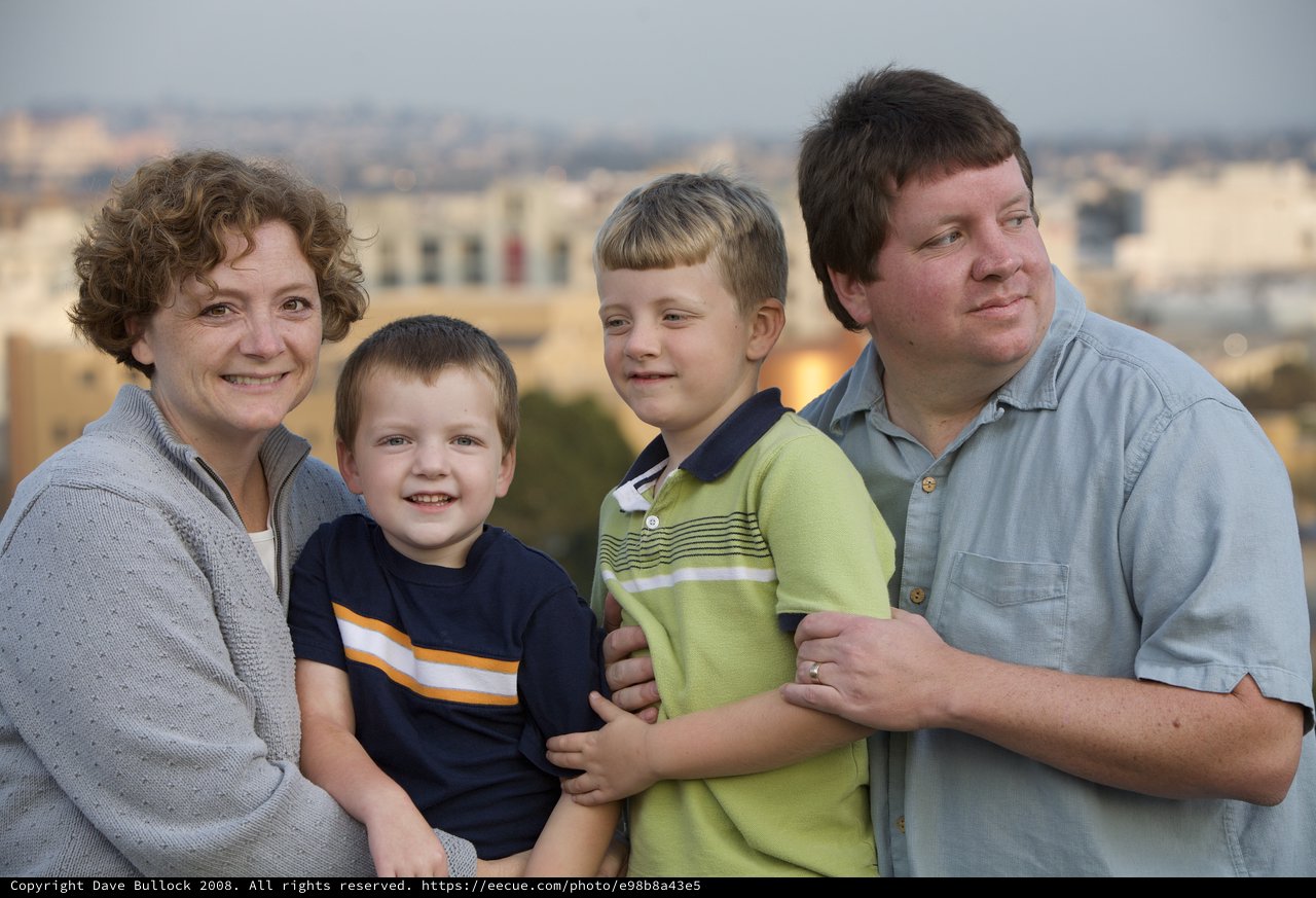 Family Portrait at Dusk with City Skyline