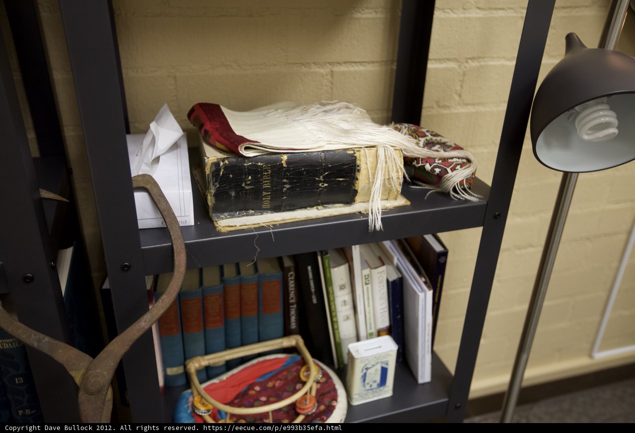 Cozy Bookshelf with Lamp and Hat