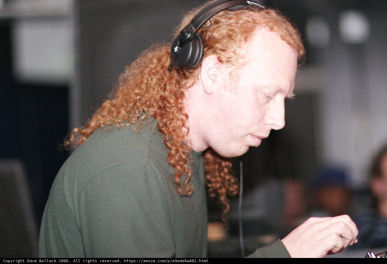 Red-Haired DJ Grooving with Headphones