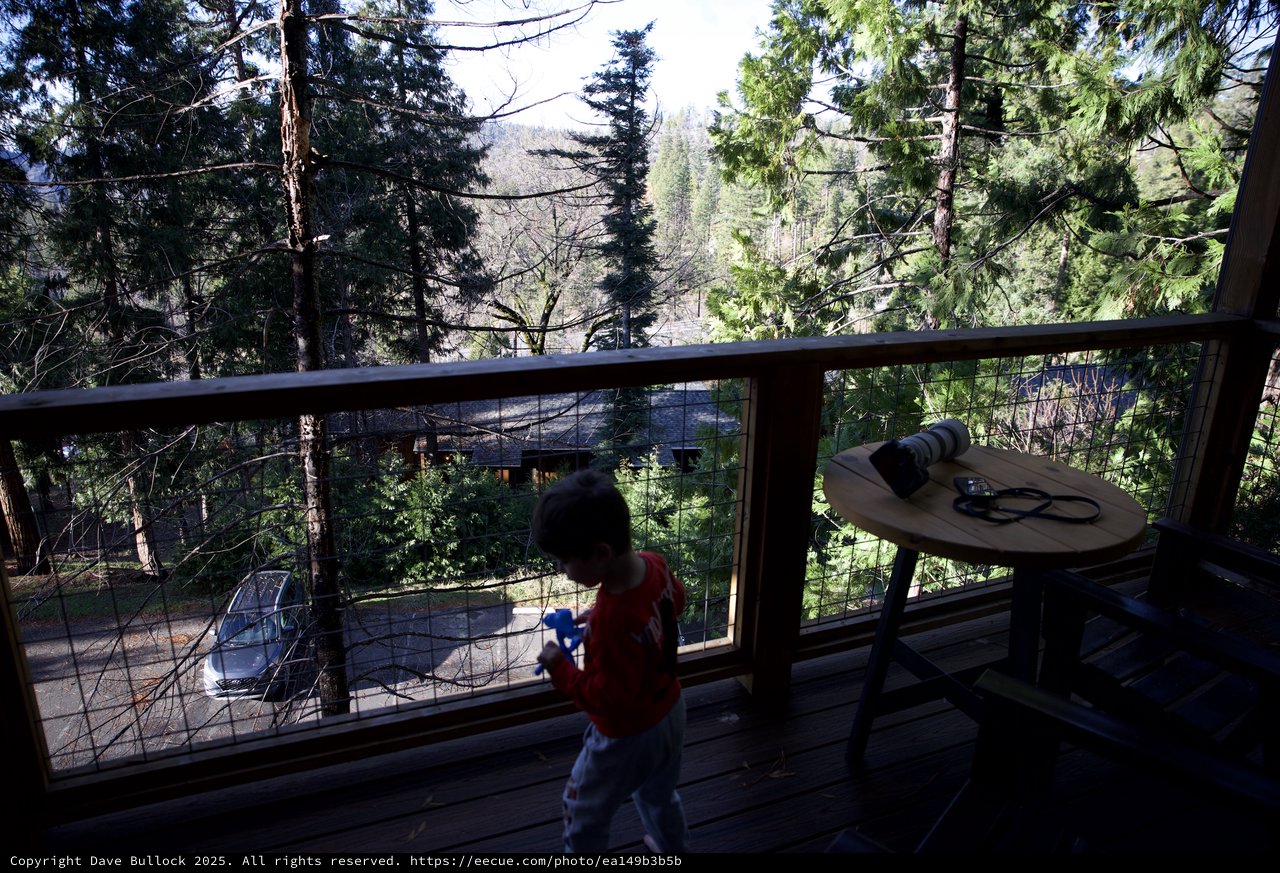 Child Playing on Mountain Cabin Deck at Sunset