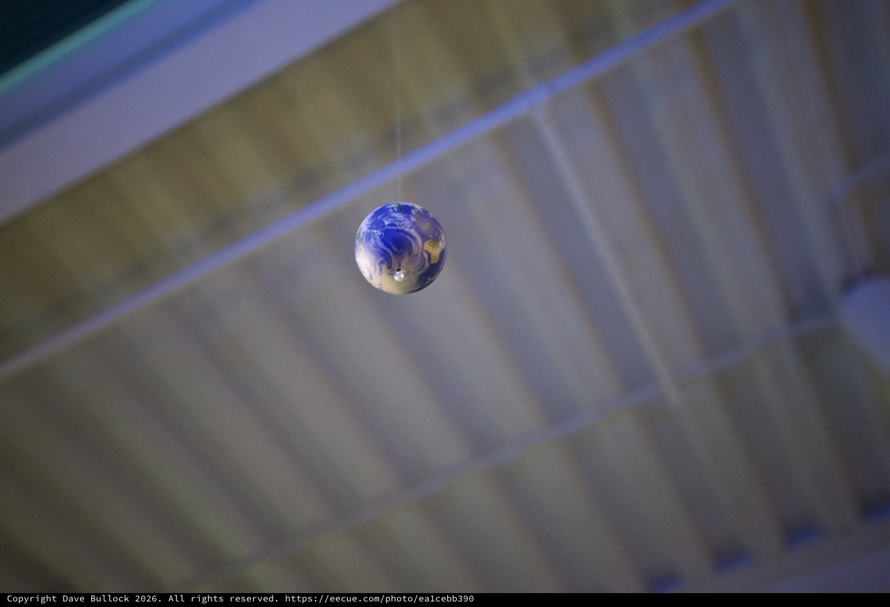 Earth Marble Suspended in Mid-Air Reflection