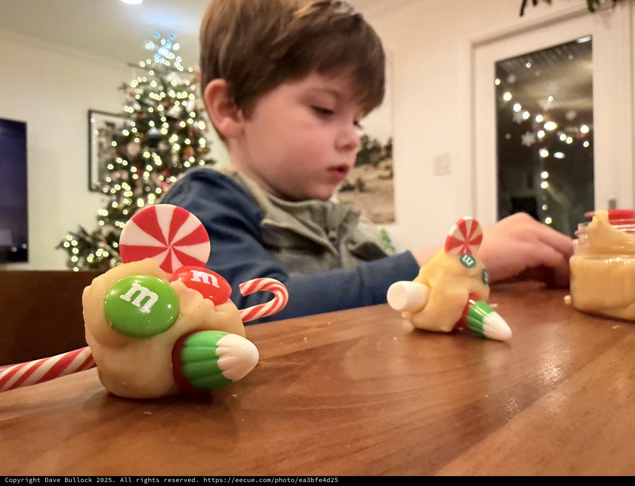 Child Decorating Gingerbread House on Christmas Eve