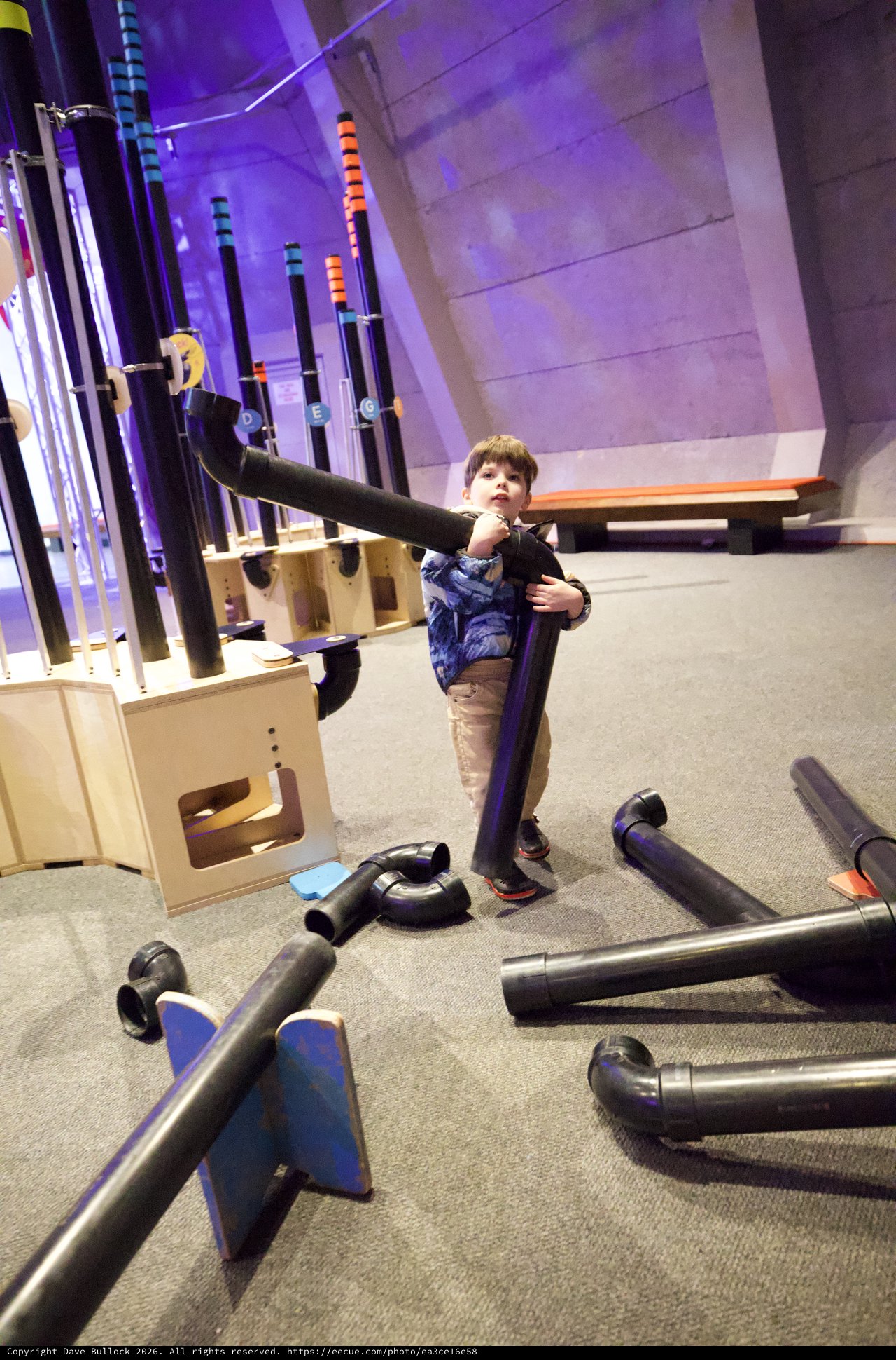 Young Boy Building with Foam Tubes at Interactive Museum