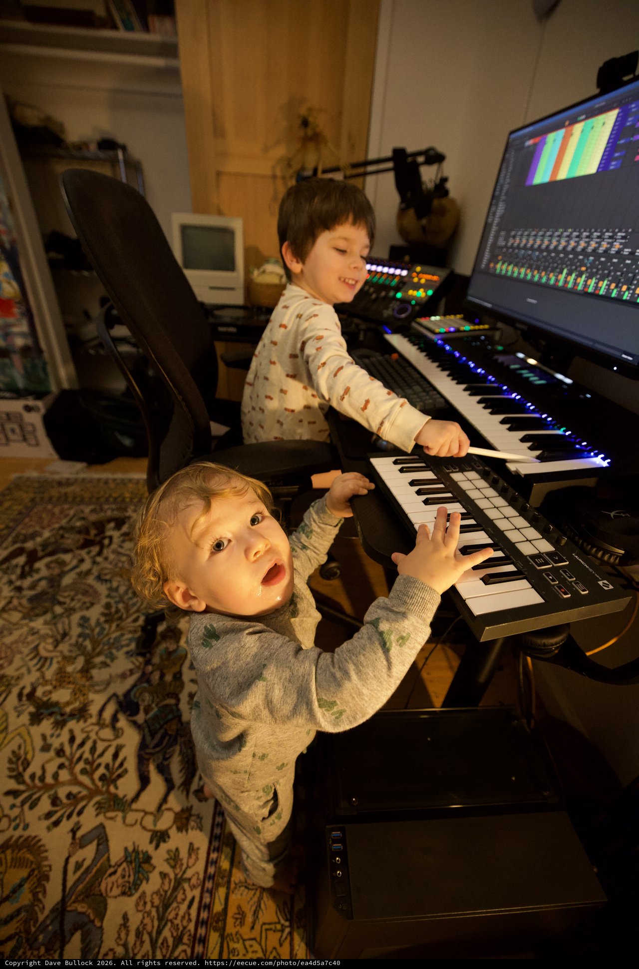 Two Young Children Playing Music Keyboard in Home Studio