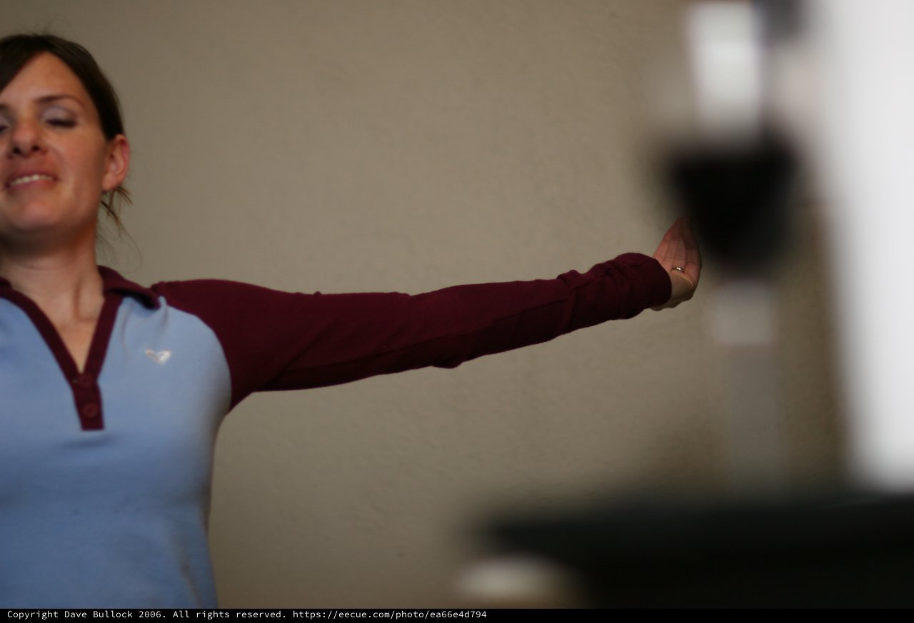 Woman Extends Arm in Graceful Indoor Gesture