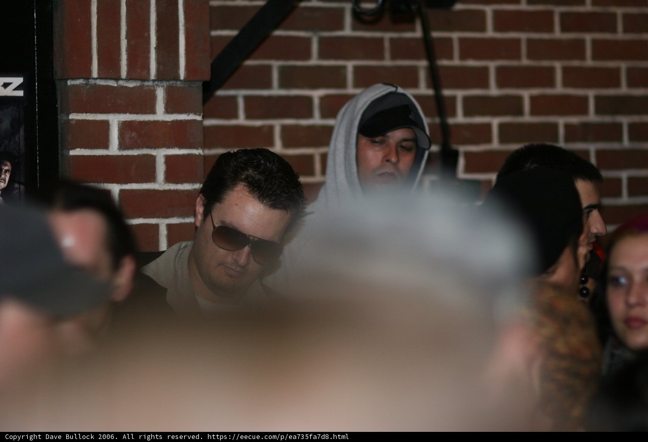 DJ Craze surrounded by fans wearing hoodies