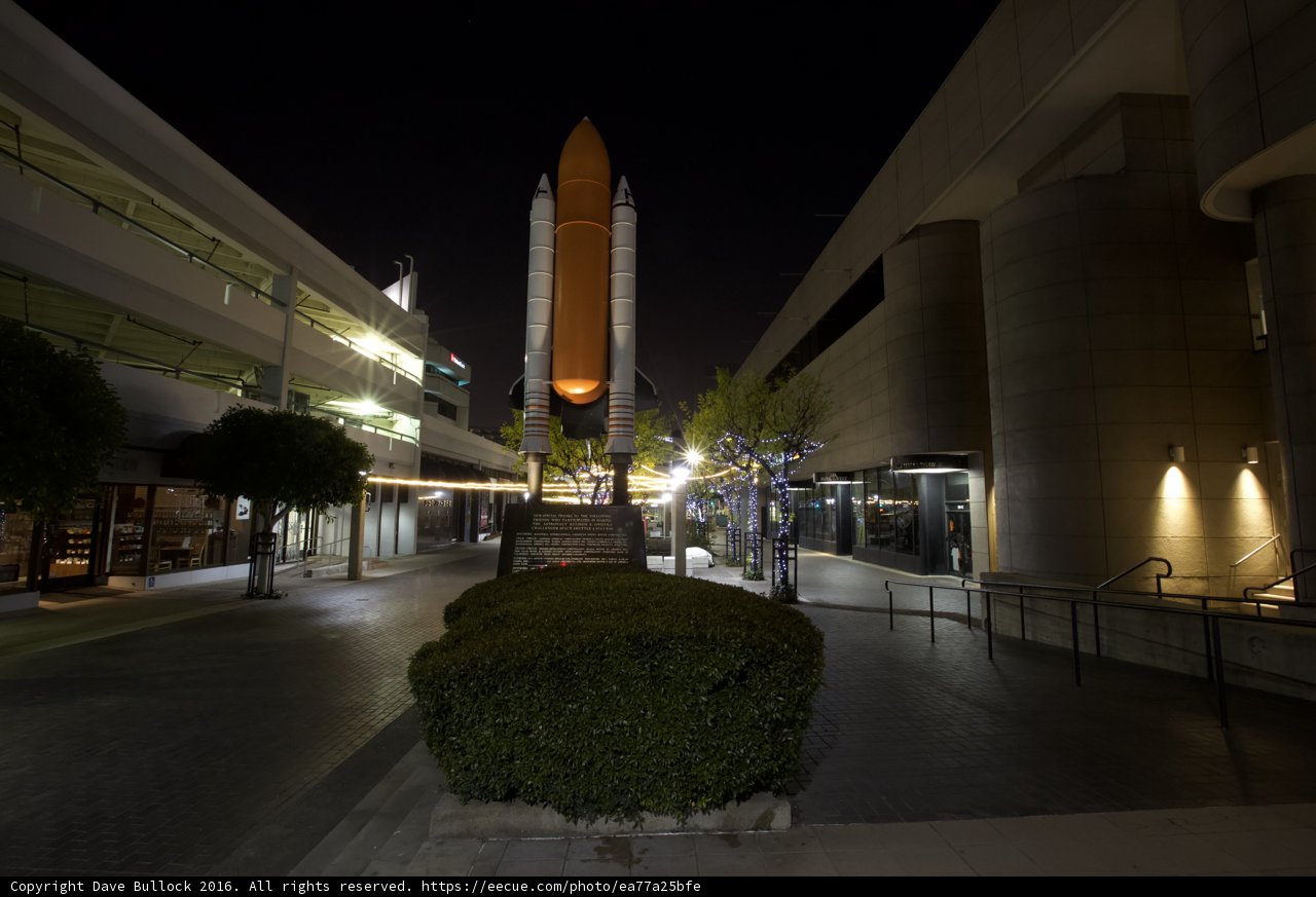 Orange Spaceship on City Sidewalk