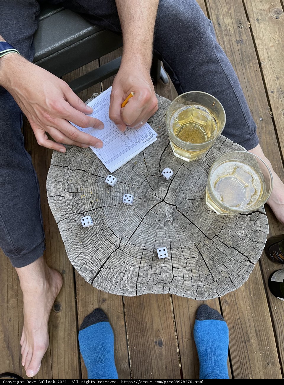 Man Playing Dice on Wooden Deck