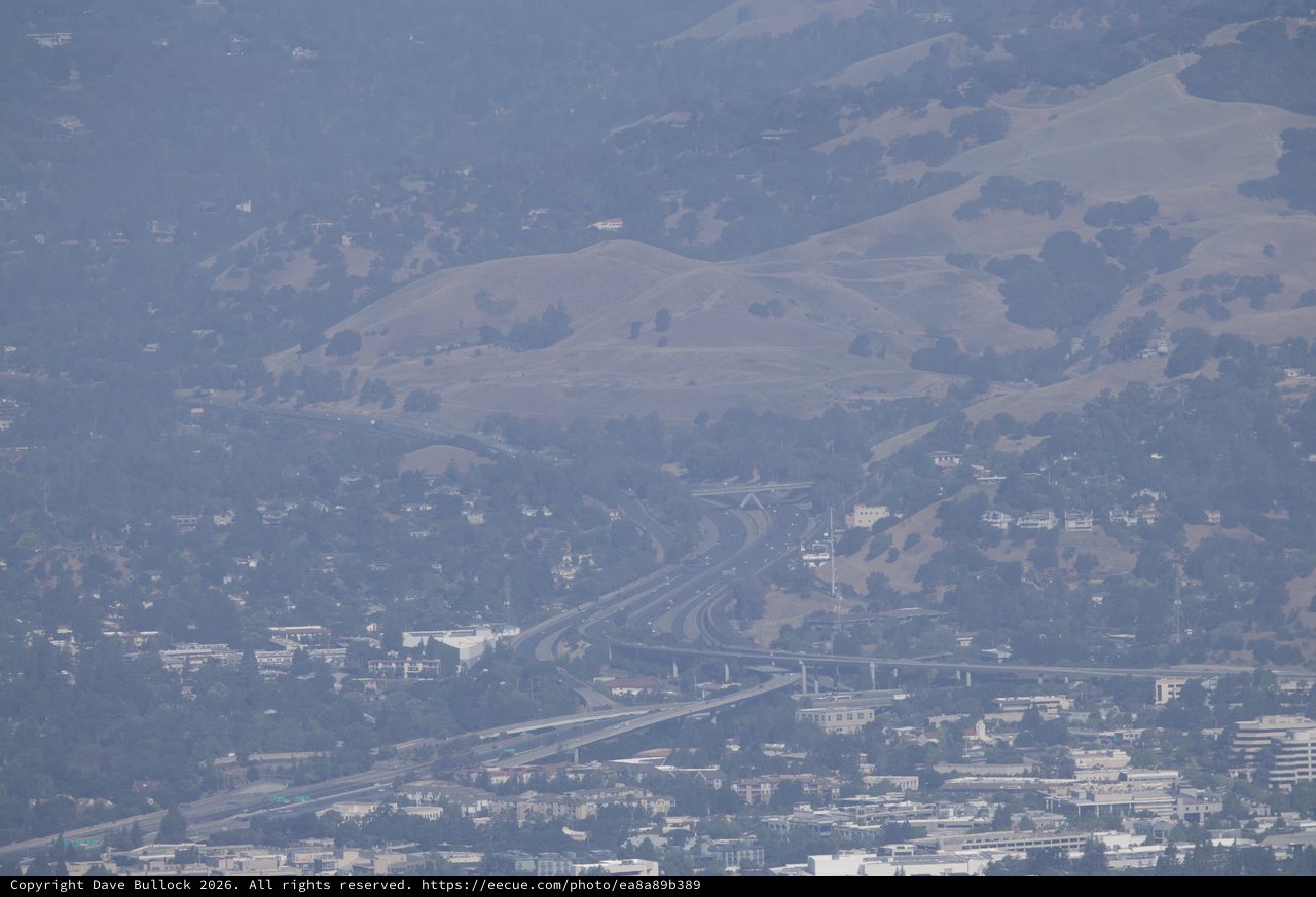 Hazy Interstate Interchange Beneath California's Rolling Hills
