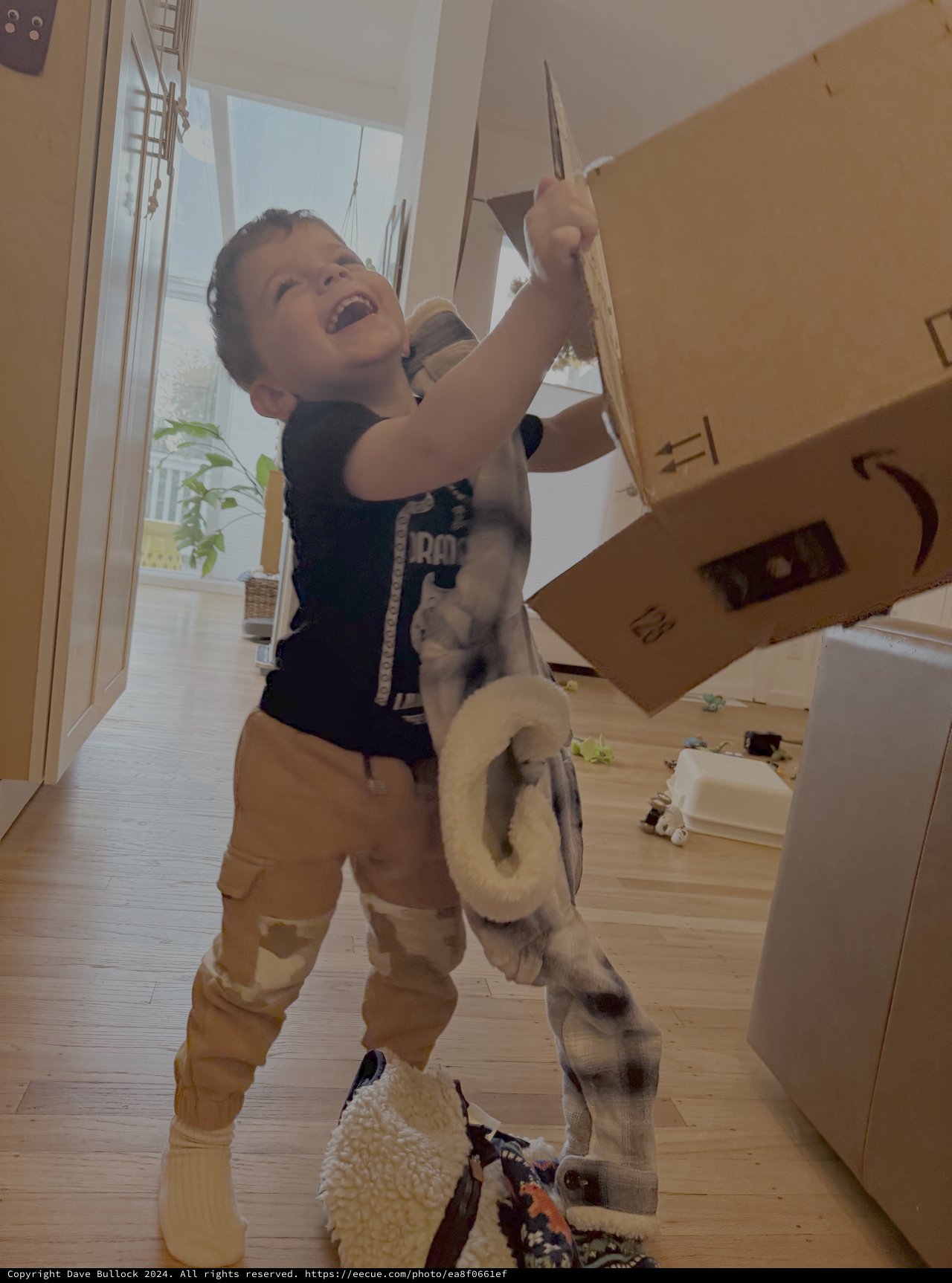 Child Joyfully Playing with Kitchen Utensils at Home