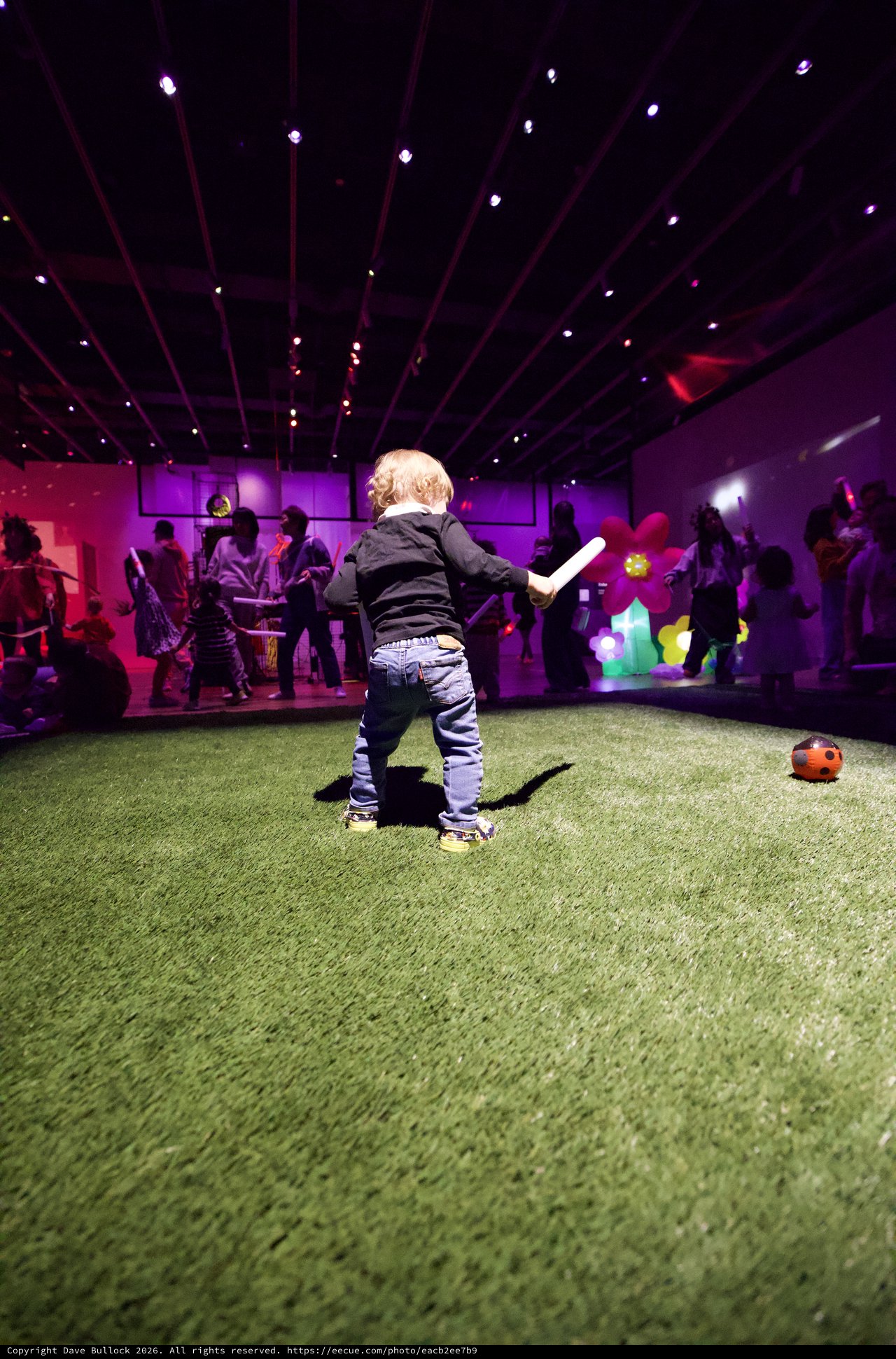 Toddler Playing at Baby Rave in Purple Neon Museum