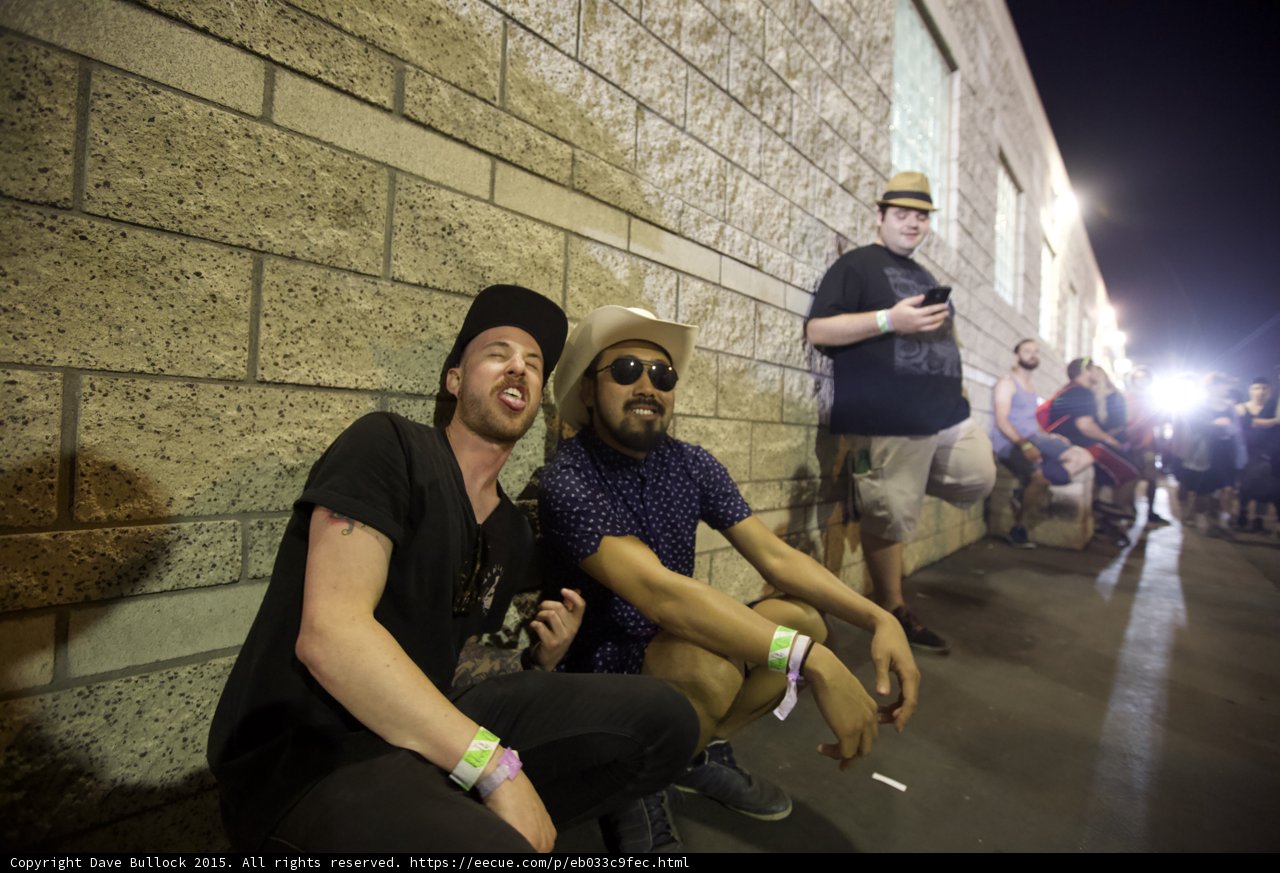 FYF Fest Two Friends Cinder Block Wall Black Cap Tongue Out Cowboy Hat Sunglasses Night
