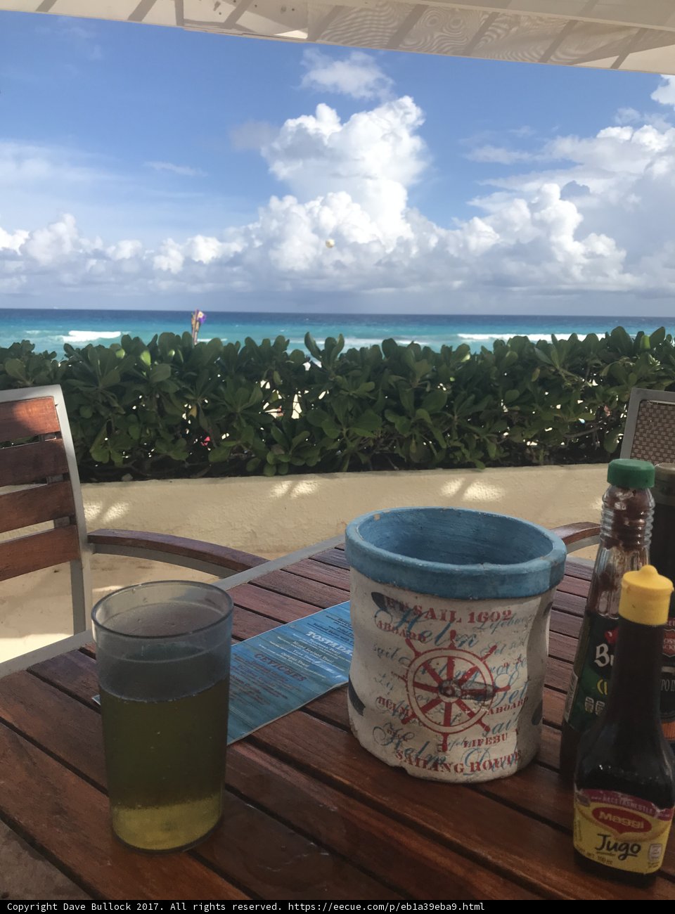 Refreshing Drink and Bucket of Food by the Ocean