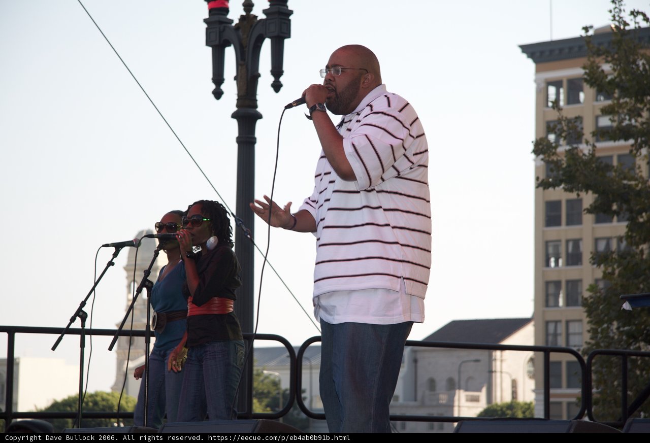 Entertainer Gift of Gab performing on stage with backing vocalists