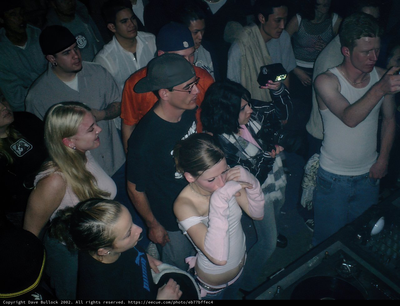 Nightclub Crowd Gathers around DJ