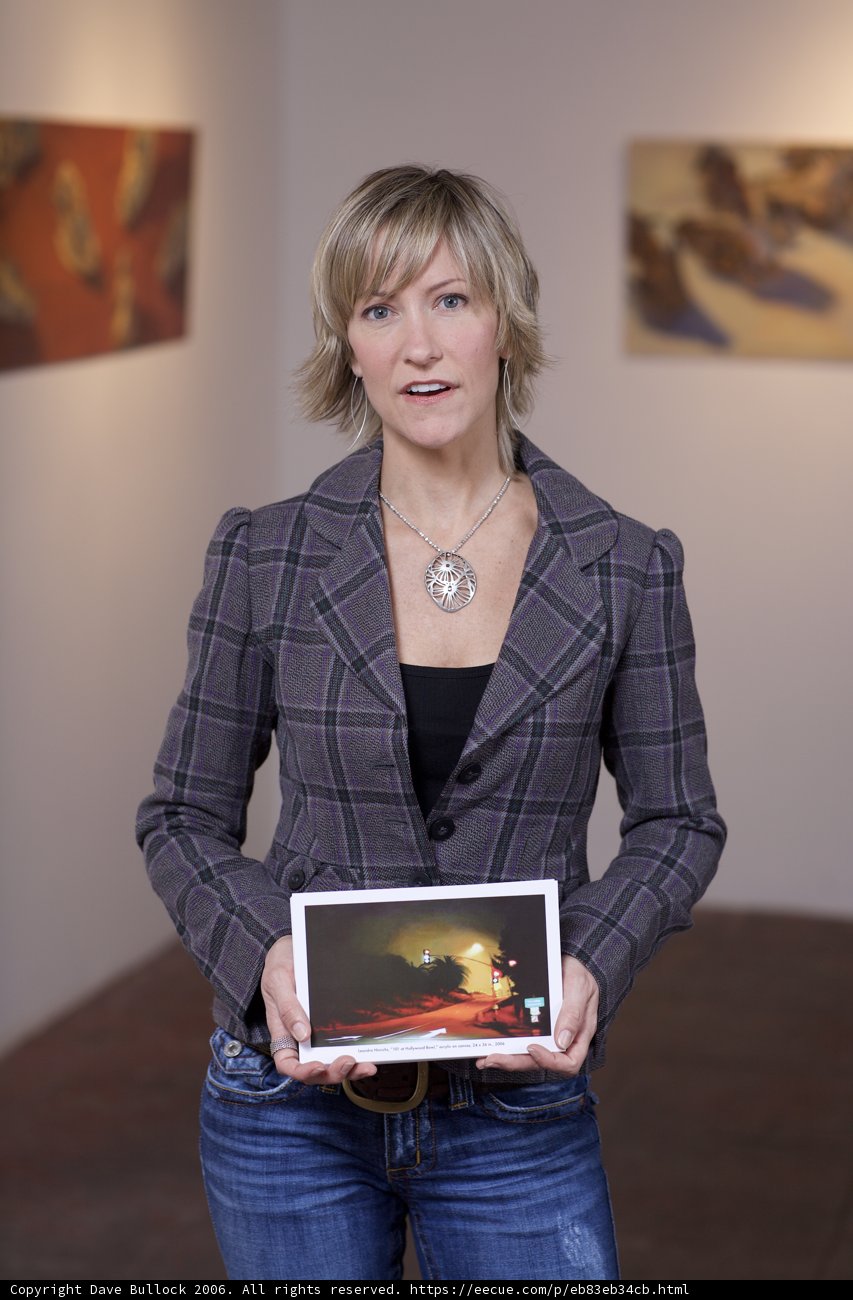 Woman Examining Paintings on Tablet Computer