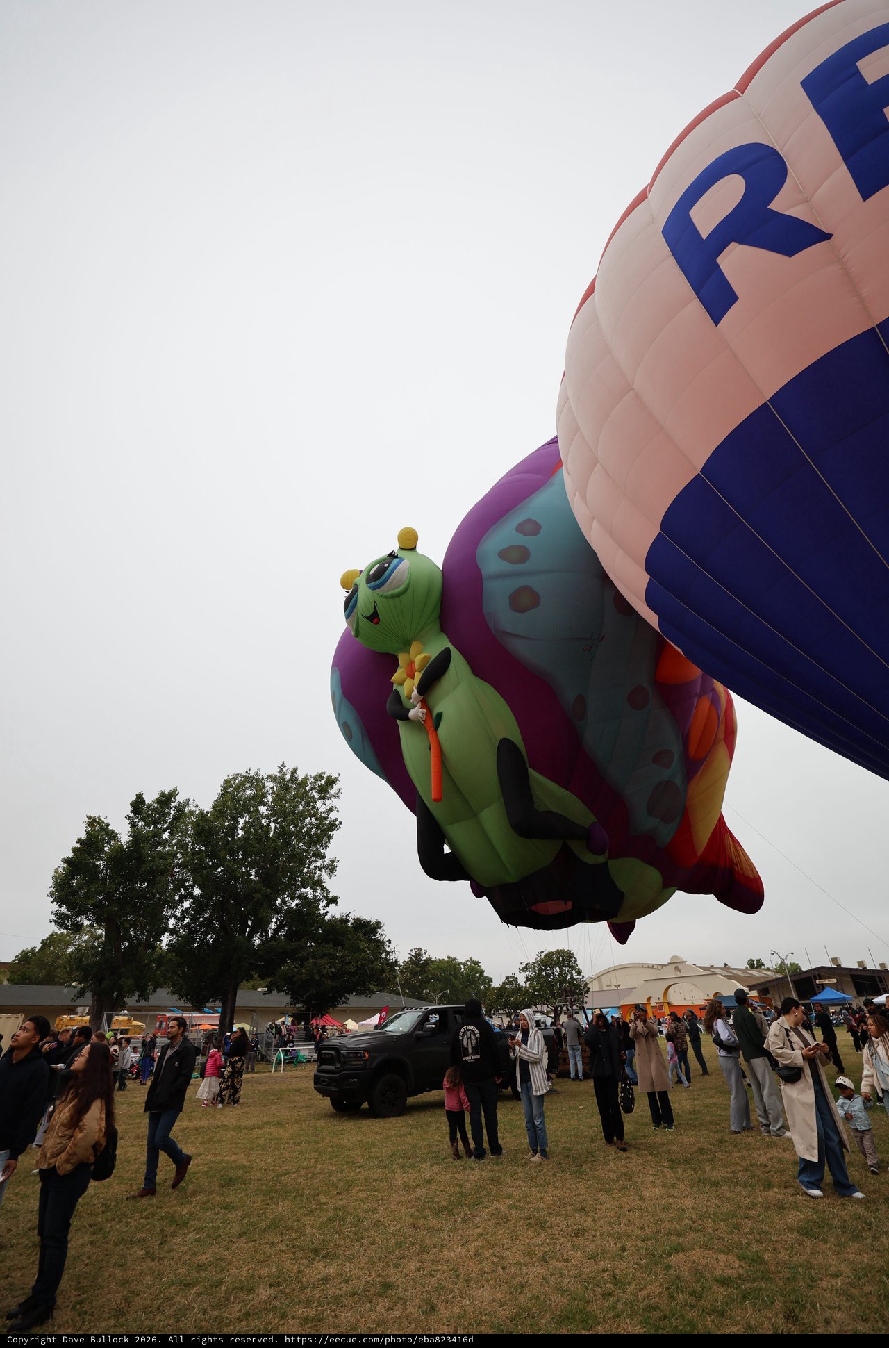Whimsical Caterpillar Balloon Towers Over Festival Crowd