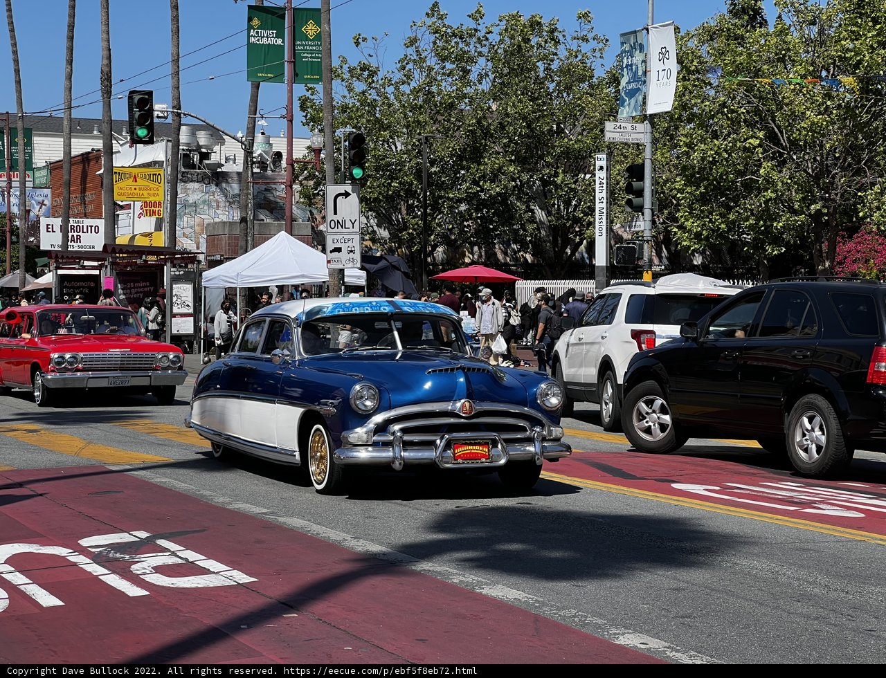 Vintage Car Cruising Through Crowded City Street