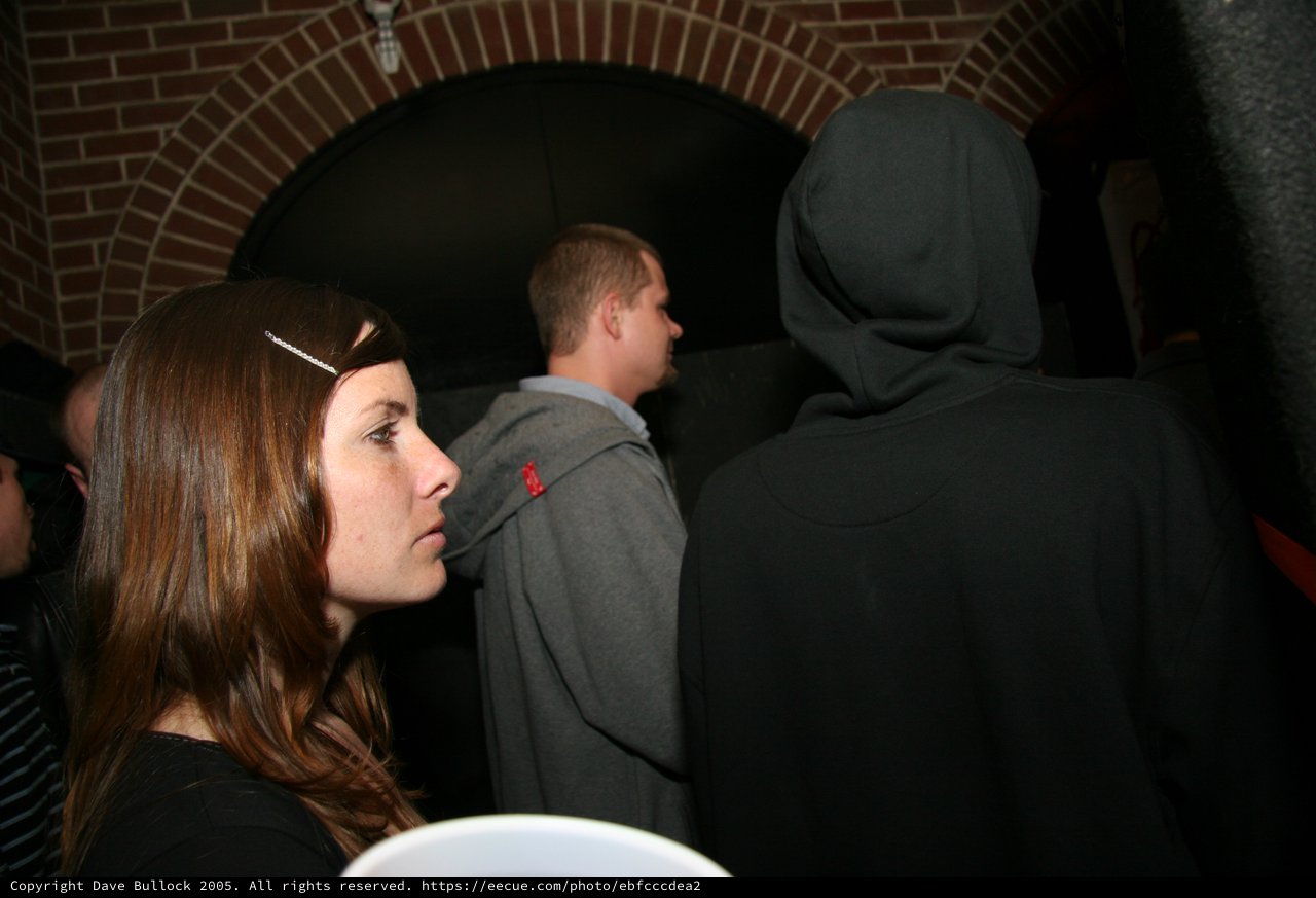 Woman in Profile at a Dimly Lit Indoor Venue