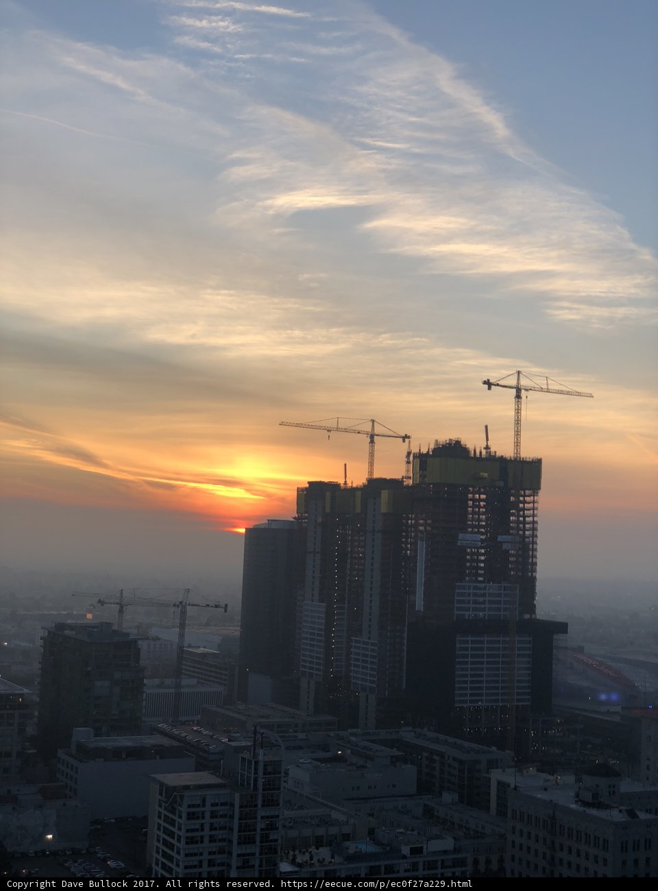 City Skyline at Sunset with Construction Cranes