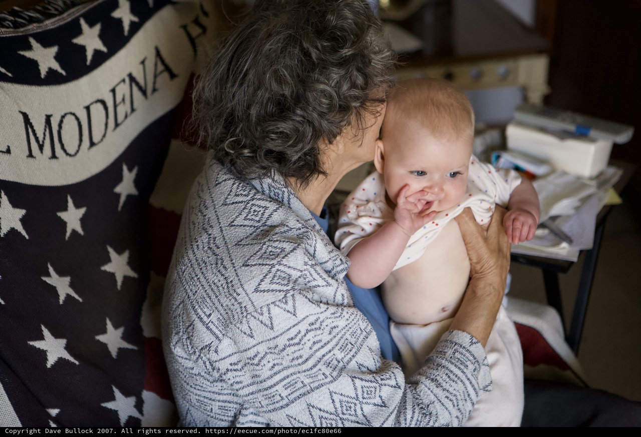 Grandmother's Tender Moment with Smiling Baby