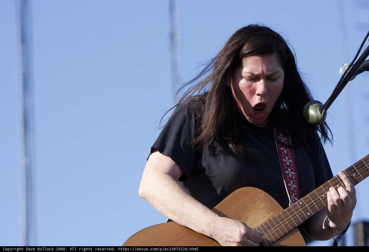 Kim Deal strums her acoustic guitar at Coachella 2008