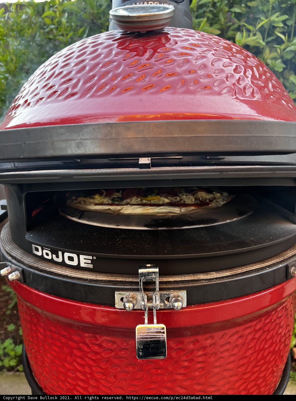 Red BBQ Grill with Mouth-Watering Pizza