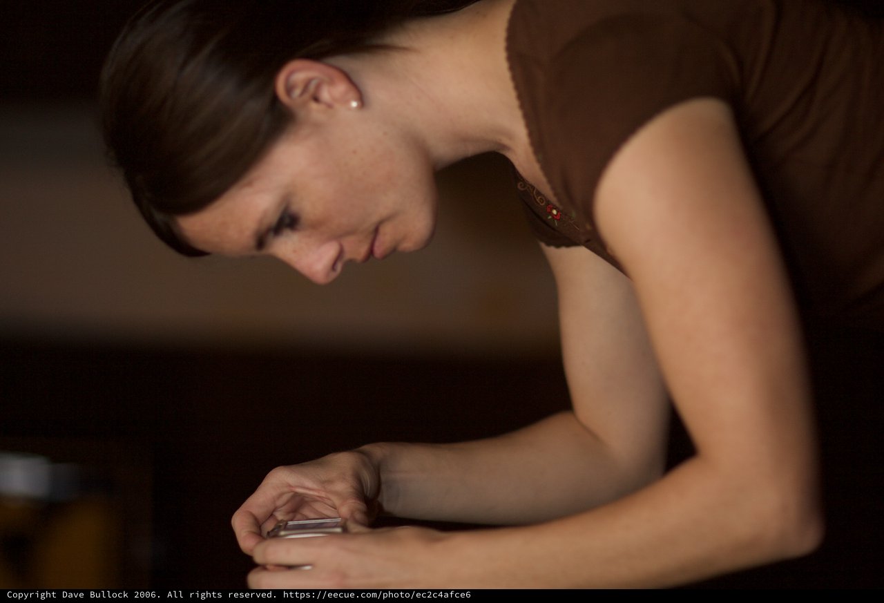 Woman Captures a Moment at Evening Art Walk